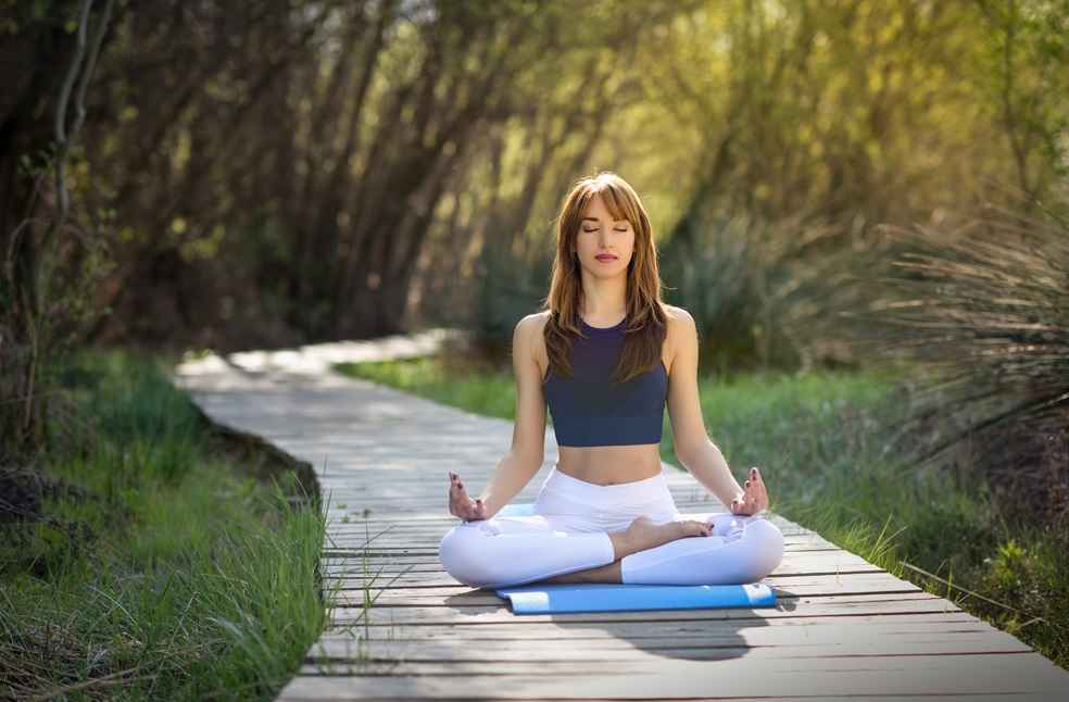 woman doing yoga nature