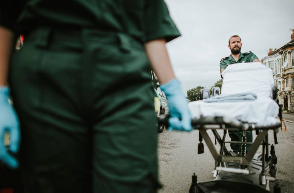 Paramedic team rolling a stretcher on a street