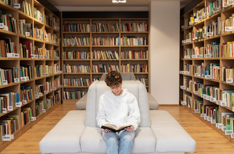 Young student learning in the library