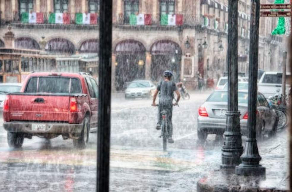 Person riding bicycle in heavy rains