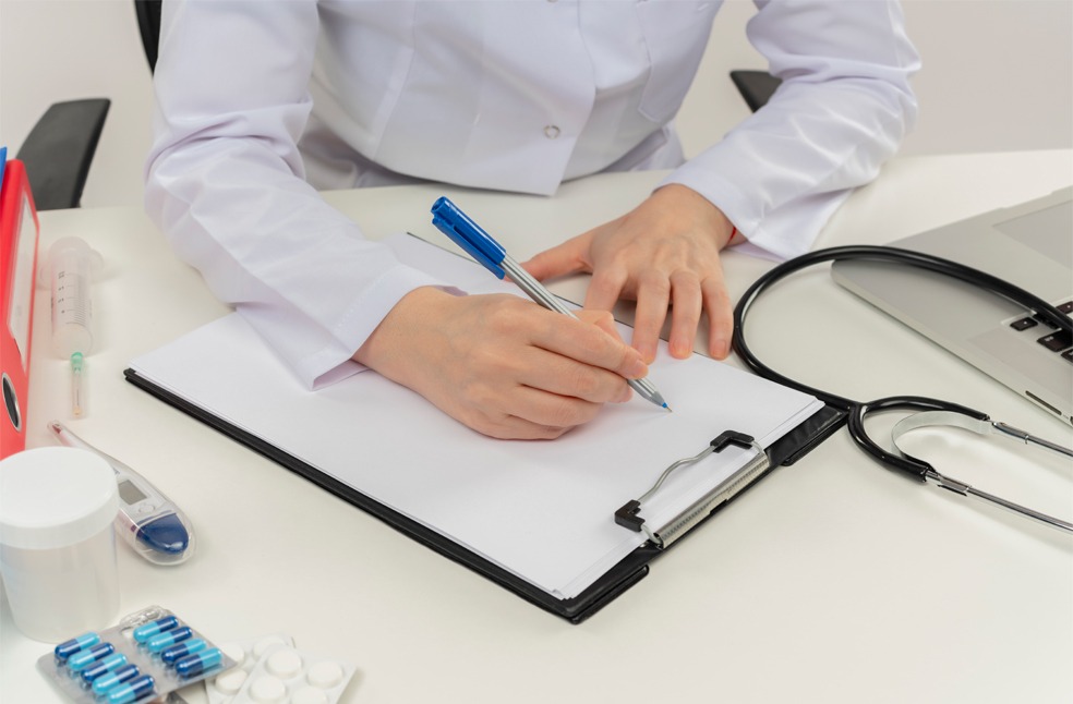 A doctor writing down medical prescriptions