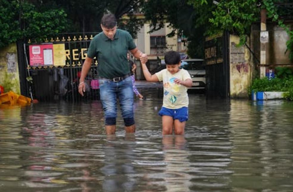 Father and Son Walking on a Flooded Street