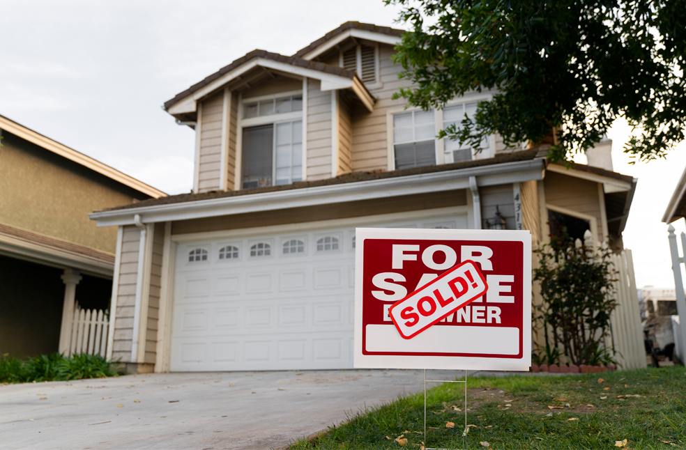 House with sold yard sign