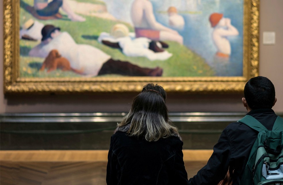 People looking a picture in the art gallery