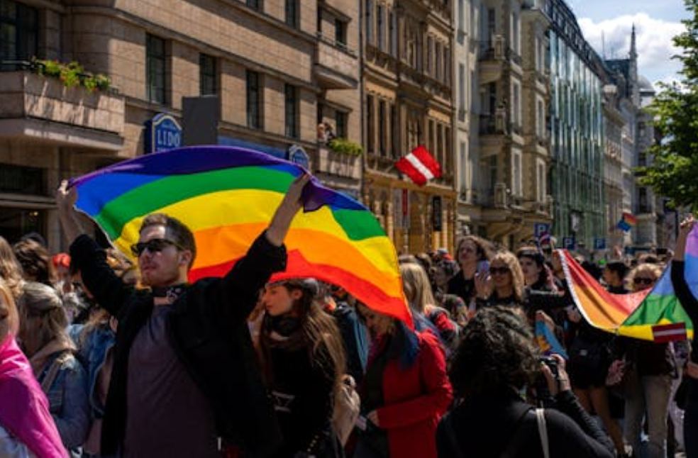 People Holding Rainbow Flags on a Parade