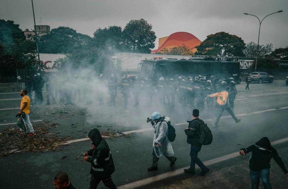 Photo of a Demonstration and a Police on a Road