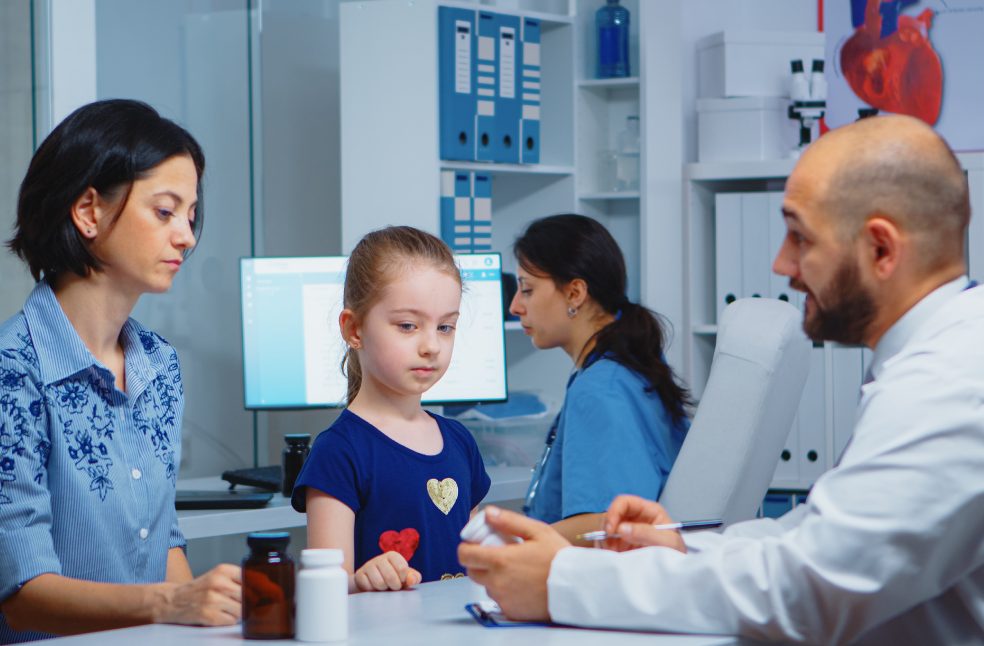 Physician writing diagnostic and treatment on clipboard
