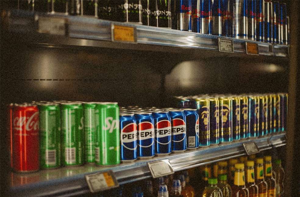 A refrigerator displays a variety of refreshments