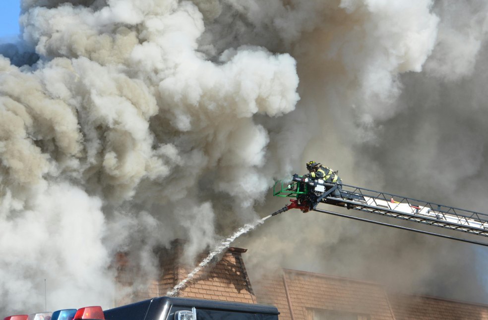 Firefighters Battling Building Blaze with Smoke
