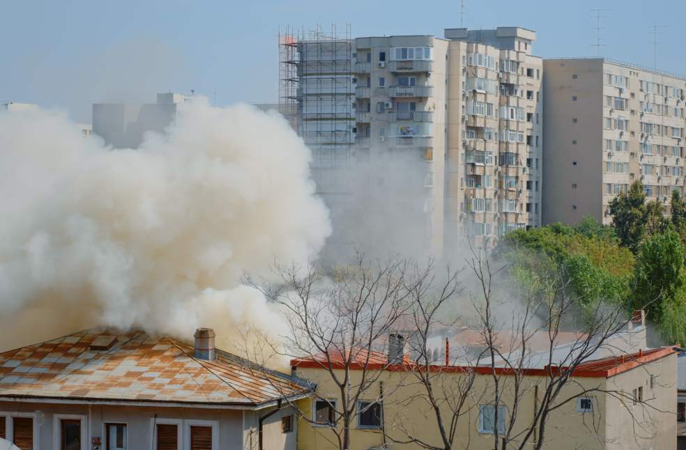 Flames going out from burning house in neighbourhood