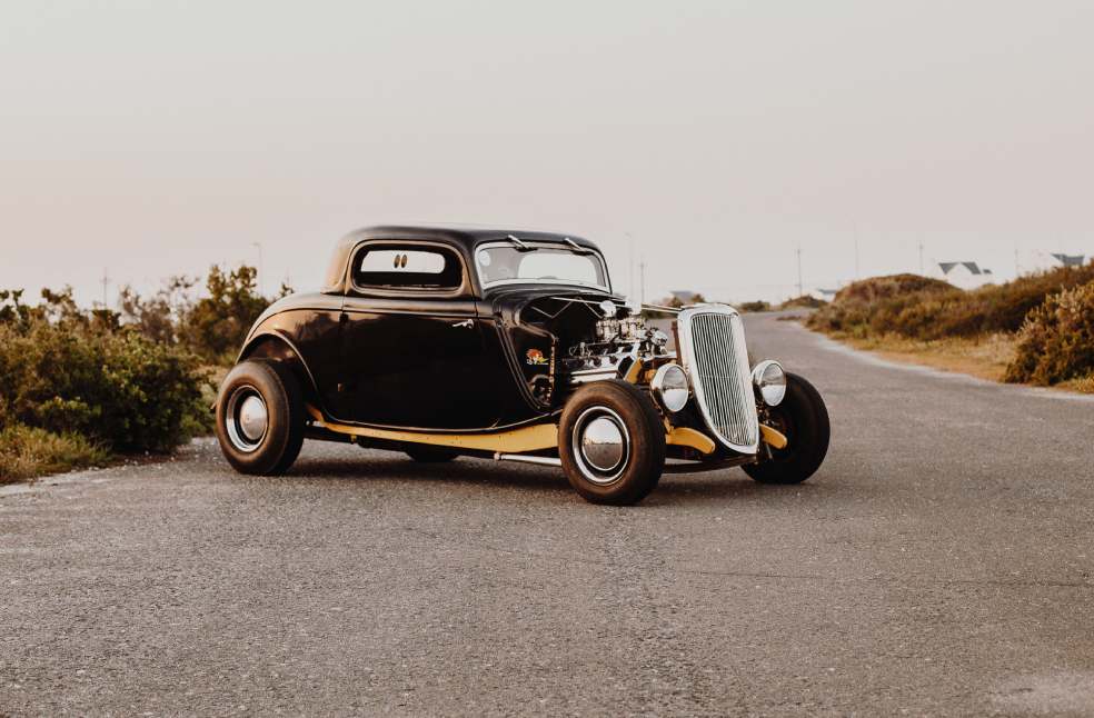 Old vintage car parked in the middle of the freeway road