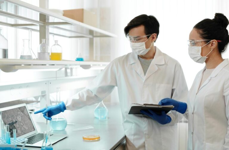 UK medical innovation struggles to reach communities Two scientists working in a laboratory during a pandemic research study