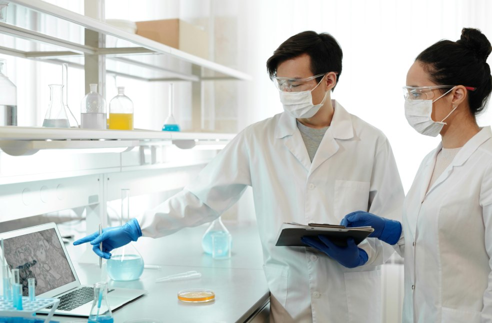 Two scientists working in a laboratory during a pandemic research study