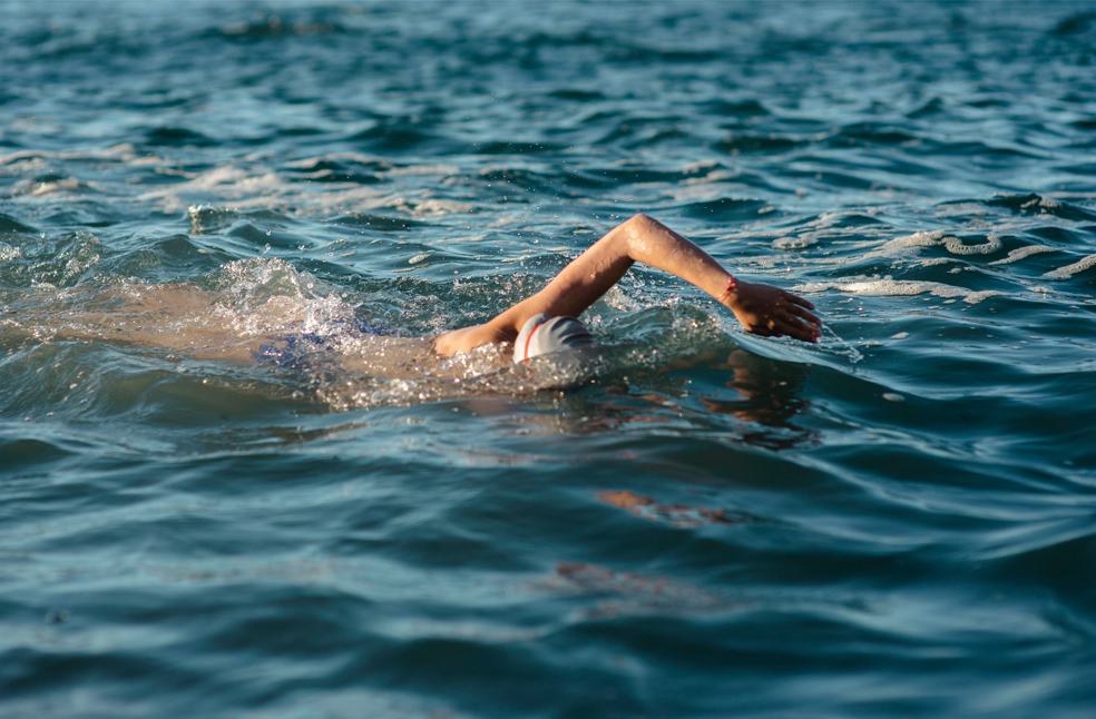 Side view of female swimmer swimming 