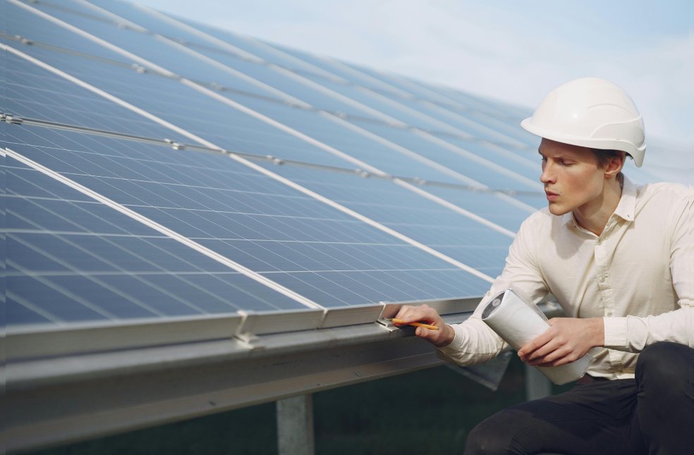 Solar Technician Inspecting Solar Panels 
