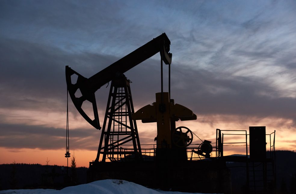 Beautiful sunset over oil field with pump jack