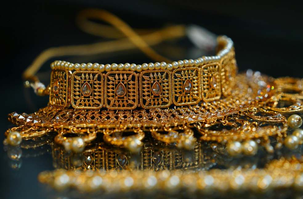 Golden precious oriental jewelry placed on table