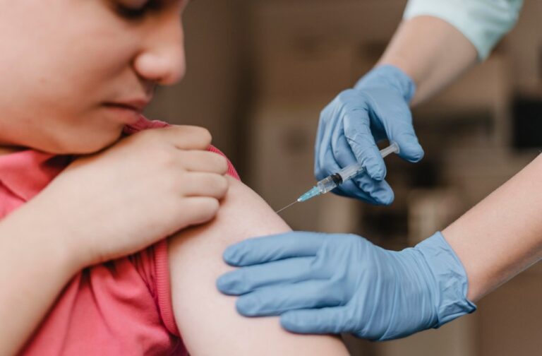 Measles outbreak in South Carolina puts US elimination status at risk Doctor administering measles vaccine to a child while wearing gloves in a clinic.