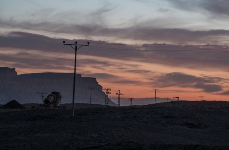 Nuuk hit by blackout after strong winds disrupt power supply Overhead power lines in the valley under the cloudy sunset sky