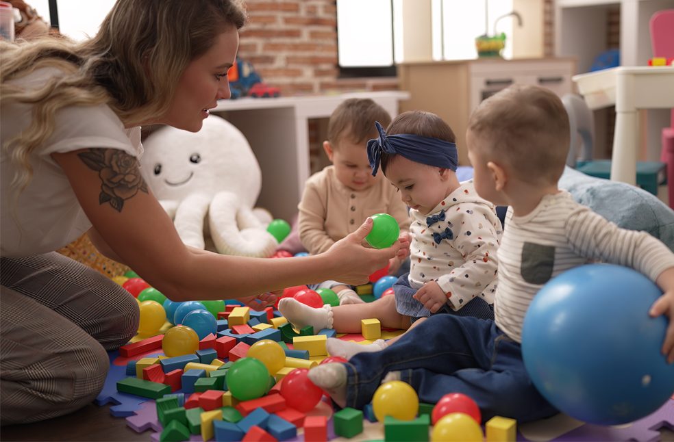 Teacher and preschool students playing