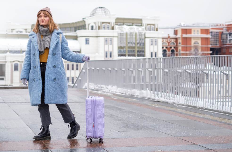 Woman with luggage at the street