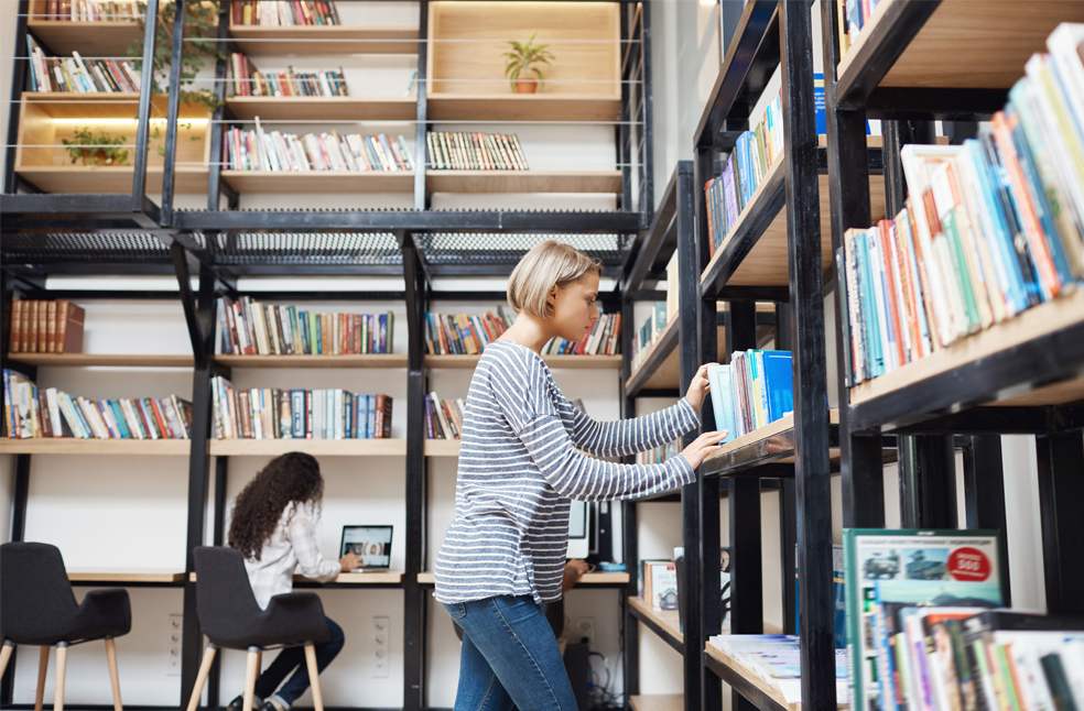 A girl searching for a book in a library
