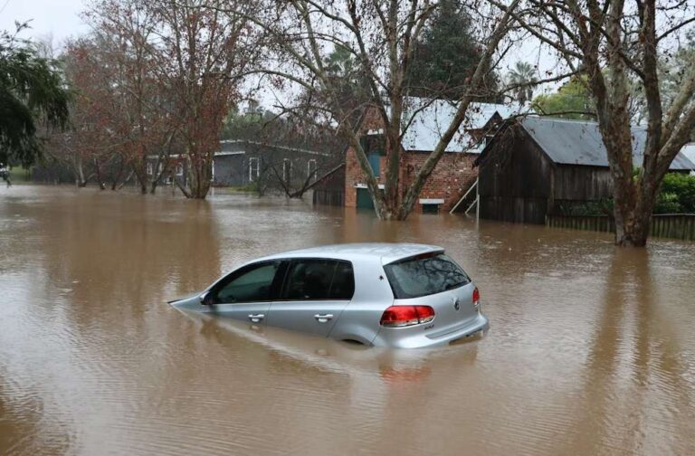 Flood warning issued as 100 Salisbury homes at risk Flooded car on city street during flood warning