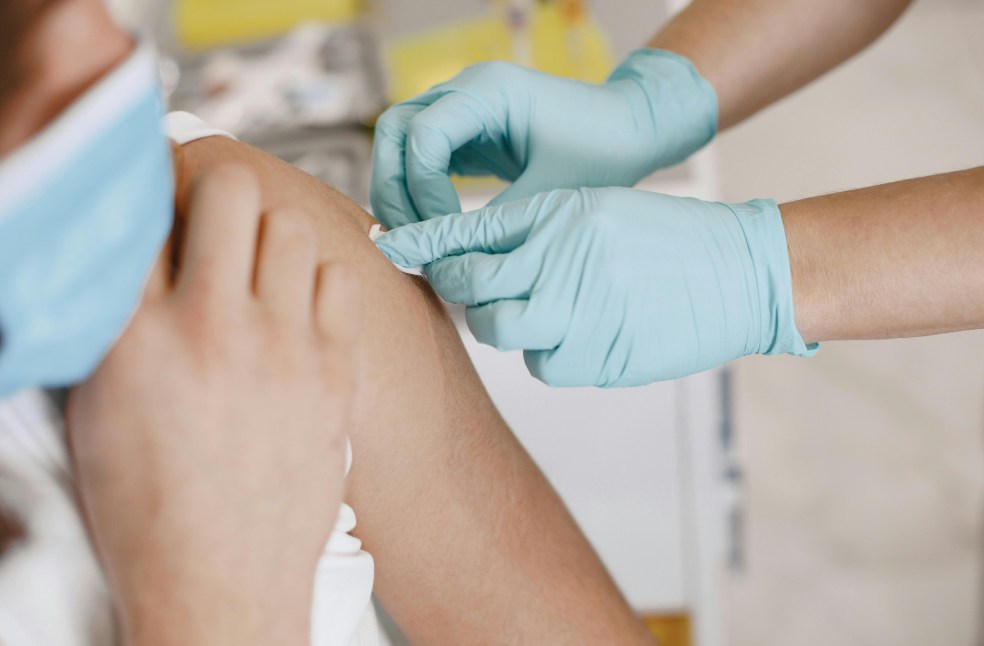 Nurse Putting a Adhesive Bandage on a Patients Arm