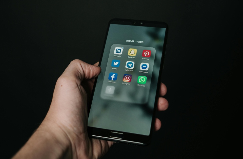 Photo of Hand Holding a Black Smartphone