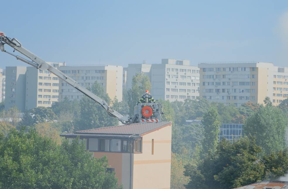 View of firemen using platform truck from fire department
