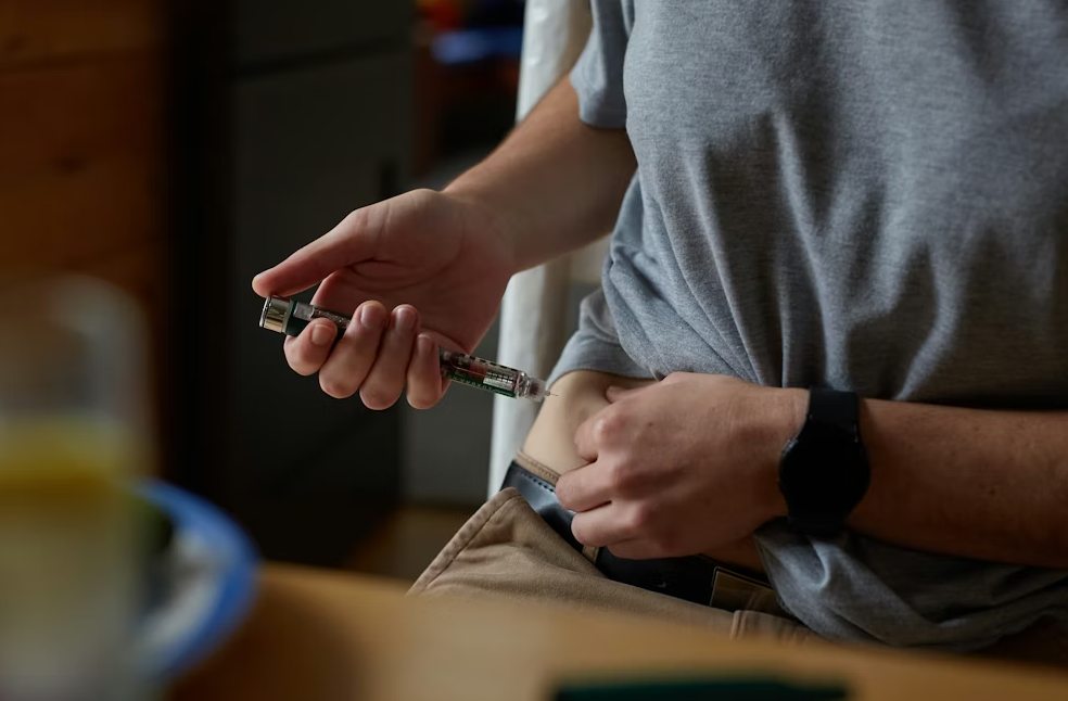 Close-up of person using Weight-loss jabs pen