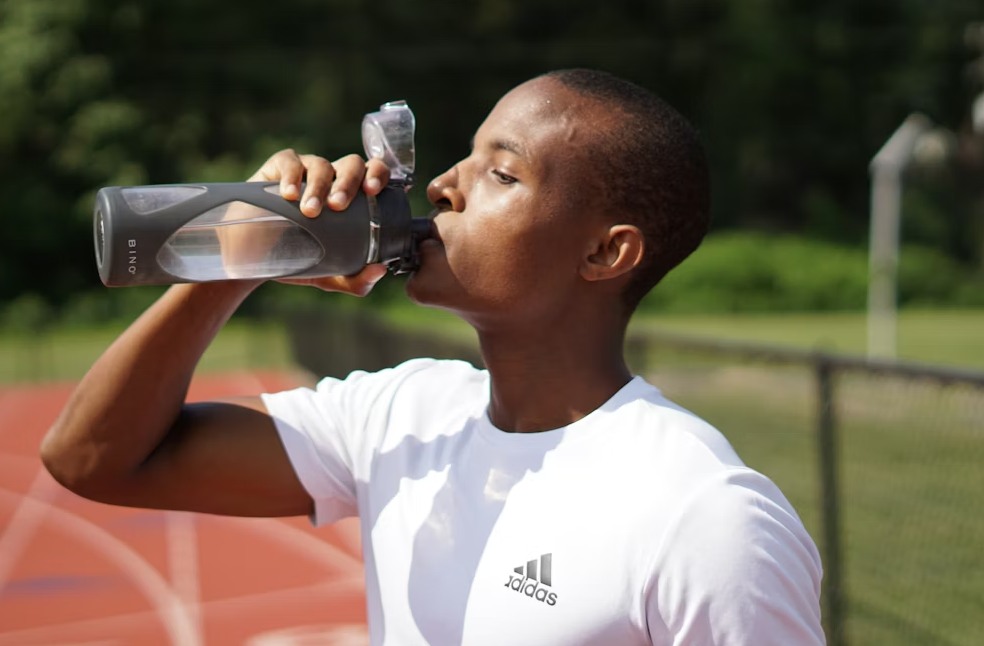 Man drinking water during the 75 Hard Challenge