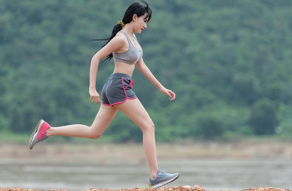 Woman walking outdoors during her daily workout for the 75 Hard Challenge