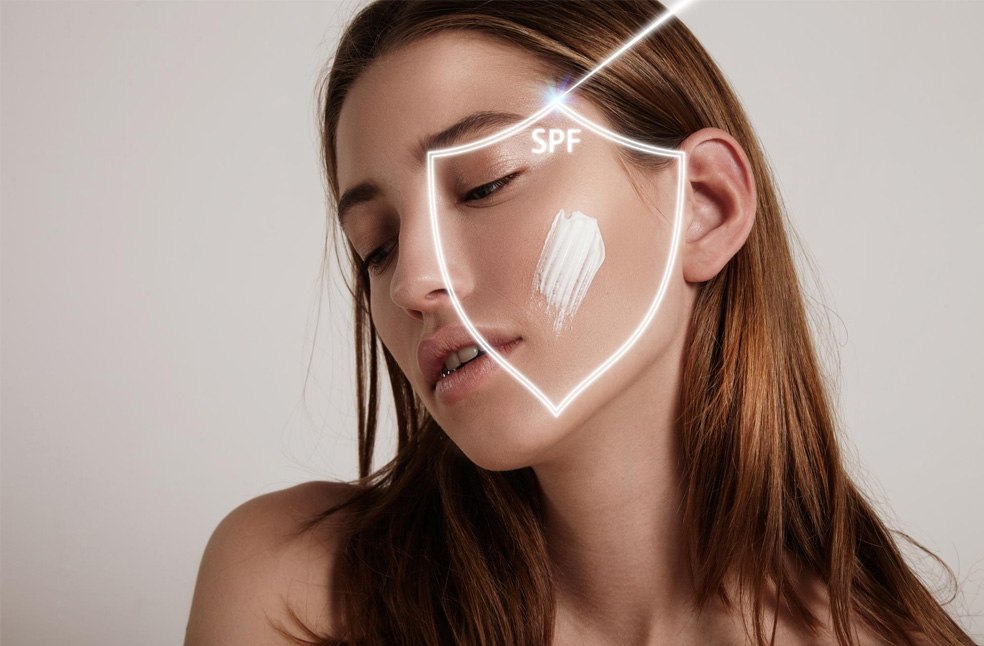 Woman's face into a shield makes spf protection