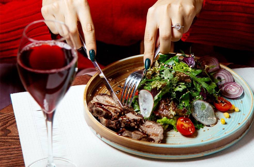 A woman eating food with forks