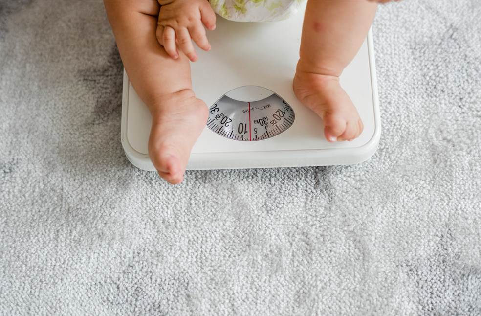 Closeup of a baby's legs on a weighing scale