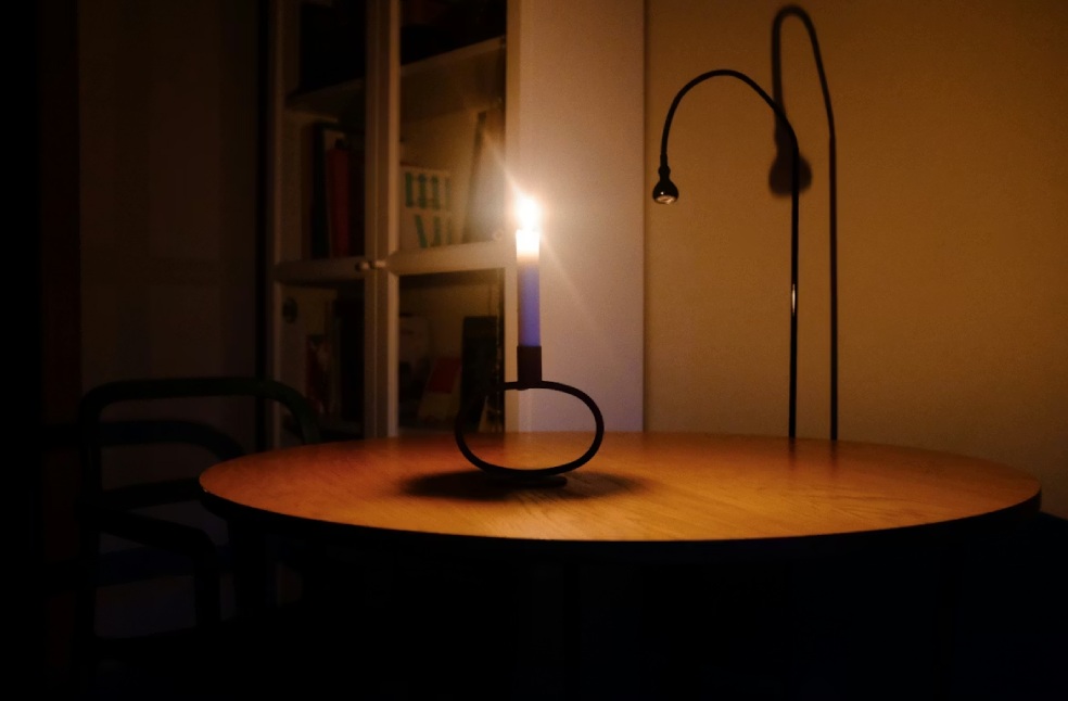 Candle burning on a table during power blackout