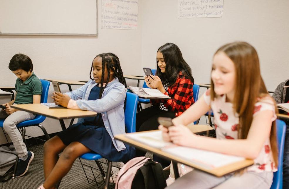 Students using smartphones in classroom reflecting social media ban