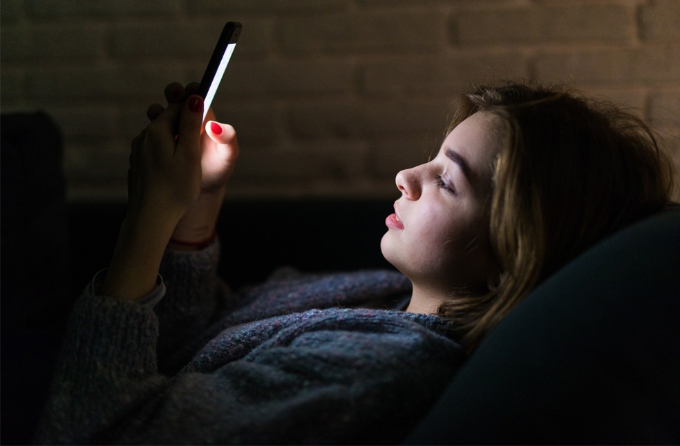 Girl checking phone at night