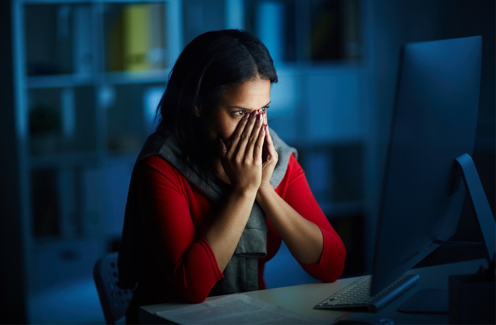 A woman alone sitting in an office