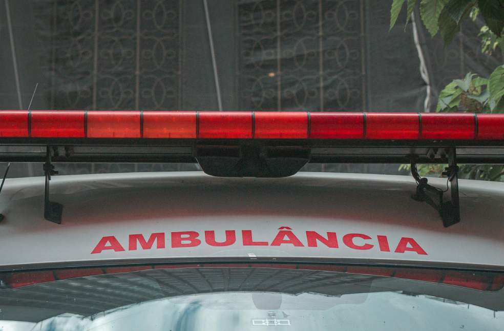 Emergency Ambulance with Red Siren Light in City