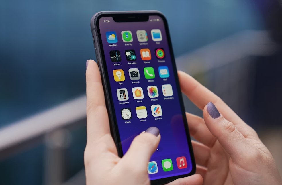 A woman holding a black iPhone