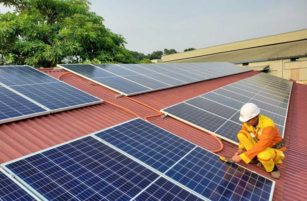 A Male Solar Technician Installing a Solar Panel
