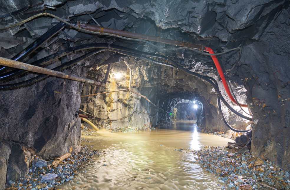 Dimly lit underground cave with flowing water