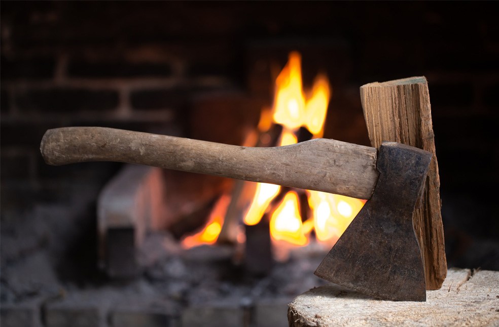 An axe near burning wood