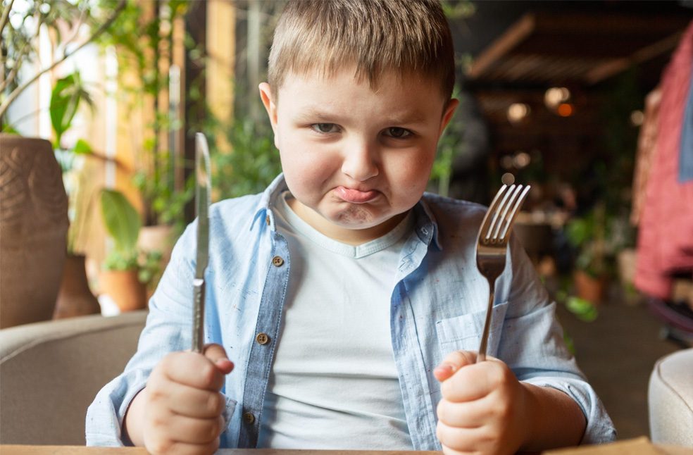 a chubby boy ready to eat food