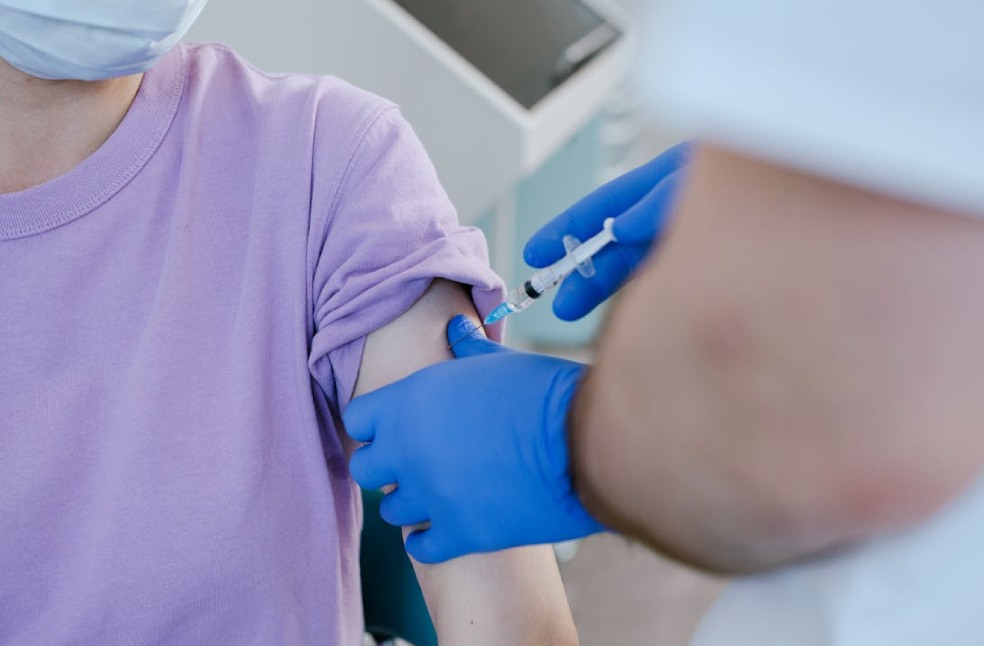 Close-up of a healthcare worker giving a vaccine shot to a patient
