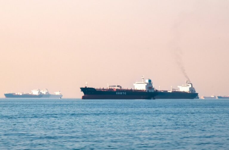 Iran declares Strait of Hormuz closed; Threatens to target passing vessels Large industrial tanker ships navigating the open sea under a clear sky