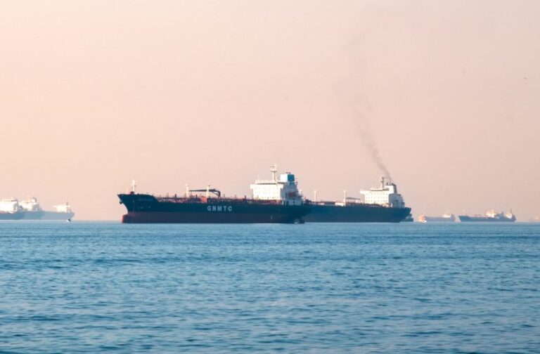 24 Indian seafarers rescued after US strike sparks fire on tanker off Oman coast Large industrial tanker ships navigating the open sea under a clear sky