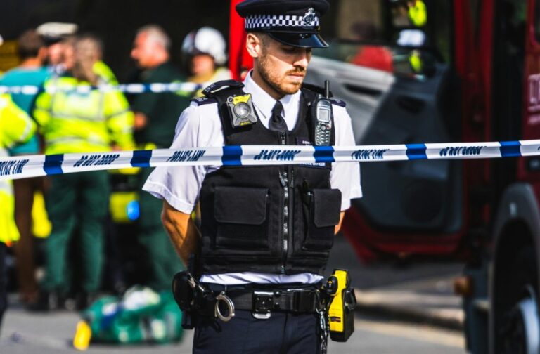 12 killed in mass shooting at Johannesburg informal settlement Police officer on duty securing a crime scene with barricade tape